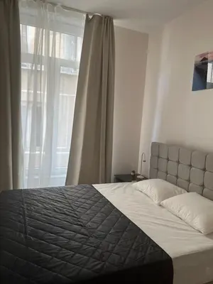 a bedroom with a large bed with a window at Exclusive two-level apartment with private terrace on the canal Brussels in Brussels