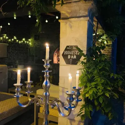 a group of candlesticks with candles on a table at B&b kleinen bosch in Beveren