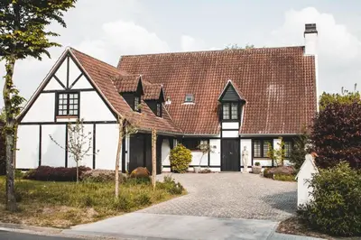 a house with a red roof and a driveway at Guesthouse Ter Linden in Bazel