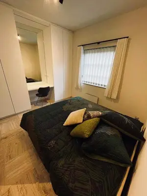 a bedroom with a large bed with pillows on it at Guesthouse Ter Linden in Bazel