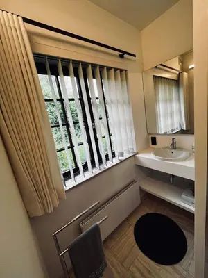 a bathroom with a sink and a window at Guesthouse Ter Linden in Bazel