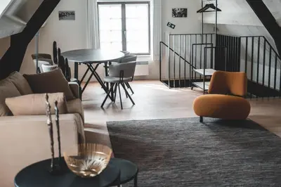 a living room with a couch and a table and chairs at Guesthouse Ter Linden in Bazel