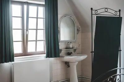 a bathroom with a sink and a mirror at Guesthouse Ter Linden in Bazel