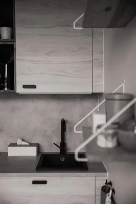 a kitchen with a sink and wooden cabinets at KROOST in Lokeren