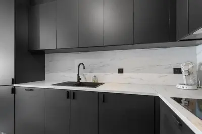 a kitchen with gray cabinets and a sink at Lappertemento in Willebroek