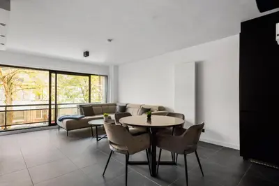 a living room with a table and chairs at Lappertemento in Willebroek