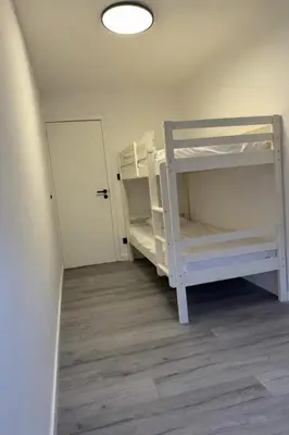 a room with two bunk beds and a door at Lappertemento in Willebroek