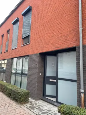 a red brick building with two garage doors at Casa Christel in Mechelen