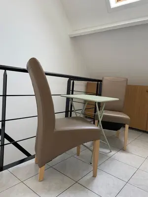 a table and two chairs sitting next to a table at Casa Christel in Mechelen