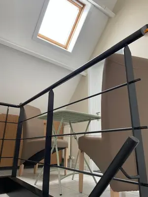 a skylight in a room with a glass table at Casa Christel in Mechelen