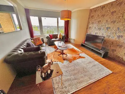 a living room with a couch and a television at Hearth of Brussels Gateway in Brussels