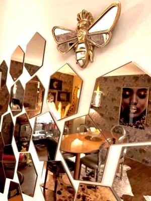 a room with mirrors and a table and a ceiling fan at Hearth of Brussels Gateway in Brussels