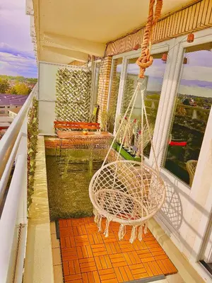 a porch with a swinging chair on a balcony at Hearth of Brussels Gateway in Brussels