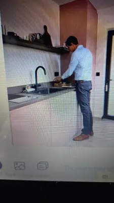 a man standing at a sink in a kitchen at Via Caput in Lokeren