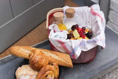 a tray with a basket of food and bread at Marcel de Gand Business & Travel in Ghent