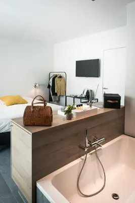 a bathroom with a sink and a bed at Marcel de Gand Business & Travel in Ghent