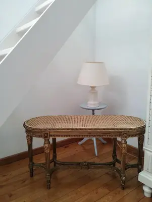 a table in a room with a lamp on a table at L Heure Bleue in Wezembeek-Oppem
