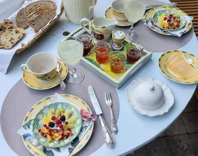 a table with plates of food and glasses of wine at L Heure Bleue in Wezembeek-Oppem