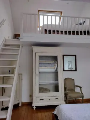 a bedroom with a loft bed and a bunk bed at L Heure Bleue in Wezembeek-Oppem