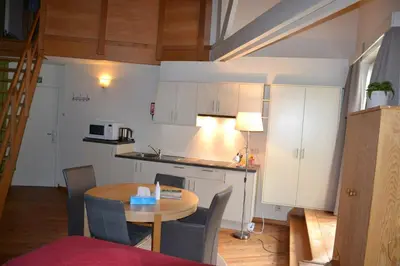 a kitchen and a table in a small room at B&B Wepa-hof in Oud-Turnhout