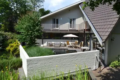 a house with a swimming pool and a patio at B&B Wepa-hof in Oud-Turnhout