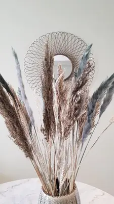 a vase with some dried grasses in it at BnB Antwerpen - CHIQUE in Antwerp