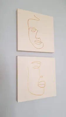 two framed drawings of heads on a wall at BnB Antwerpen - CHIQUE in Antwerp