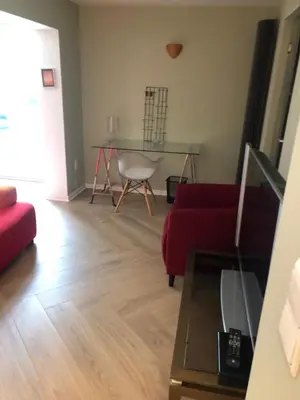 a living room with a red couch and a glass table at Belair Studio in Tervuren
