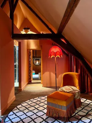 a living room with a chair and a lamp at Flora in Antwerp