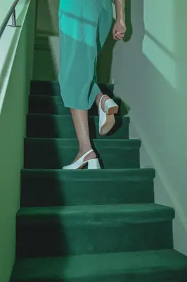 a person walking down the stairs in shoes at Flora in Antwerp