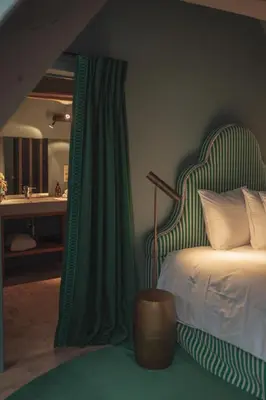 a bedroom with a bed with a green and white canopy at Flora in Antwerp