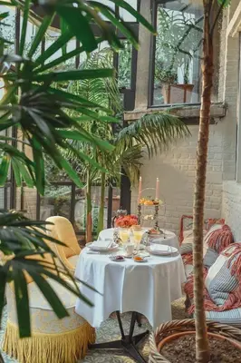 a table with a white table cloth and candles on it at Flora in Antwerp