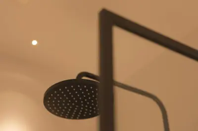 a black fan hanging from a wall in a room at MAISON KITOKO in Ghent