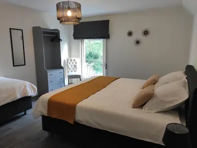 a bedroom with a large bed and a window at Villa Chill in Scherpenheuvel-Zichem