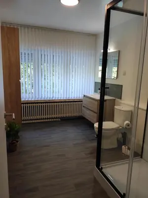 a bathroom with a toilet and a sink and a mirror at Villa Chill in Scherpenheuvel-Zichem