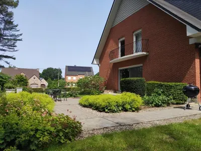 a brick building with a grill in front of it at Villa Chill in Scherpenheuvel-Zichem