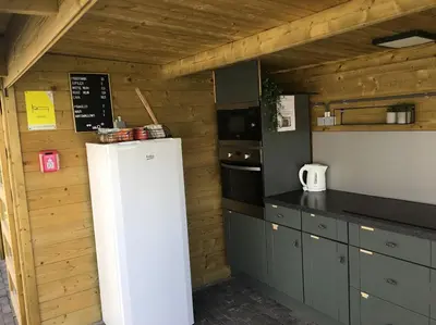 a kitchen with a white refrigerator in a room at Landgoed Omorika in Ravels