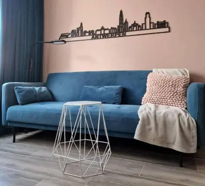 a blue couch in a living room with a table at Royal Diamond Apartment @ Central Station in Antwerp