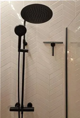 a shower with a round shower head in a bathroom at Royal Diamond Apartment @ Central Station in Antwerp