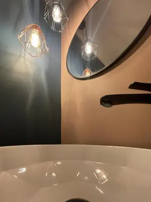 a bathroom with a sink with a mirror and lights at Royal Diamond Apartment @ Central Station in Antwerp