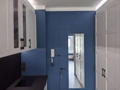 a blue room with a door and a hallway at Royal Diamond Apartment @ Central Station in Antwerp