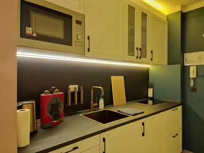 a kitchen with a sink and a microwave at Royal Diamond Apartment @ Central Station in Antwerp