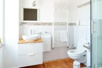 a white bathroom with a sink and a toilet at Smart Appart - Gare Du Midi in Brussels