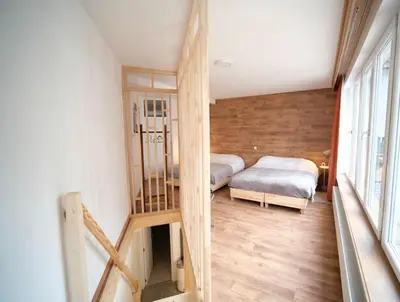 a small room with two beds and a staircase at Smart Appart - Gare Du Midi in Brussels