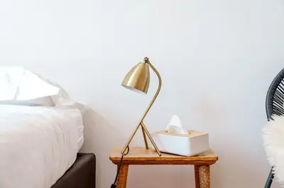 a lamp on a table next to a bed at Smart Appart - Gare Du Midi in Brussels