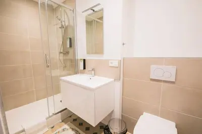 a bathroom with a toilet and a sink and a shower at Smart Appart - Gare Du Midi in Brussels