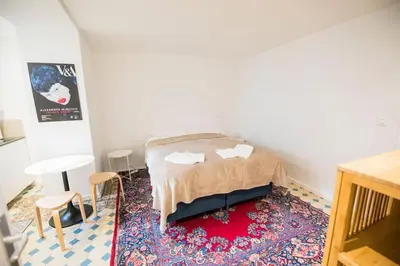 a bedroom with a bed and a rug at Smart Appart - Gare Du Midi in Brussels