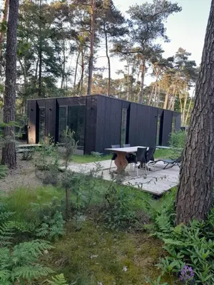 a small black house with a table and chairs at Black Box in Lille