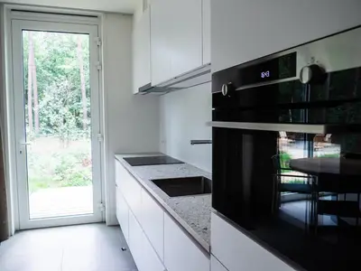 a kitchen with white cabinets and a black stove top oven at Black Box in Lille
