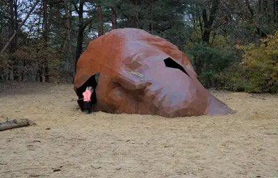 a person standing next to a sculpture of a bear at Black Box in Lille